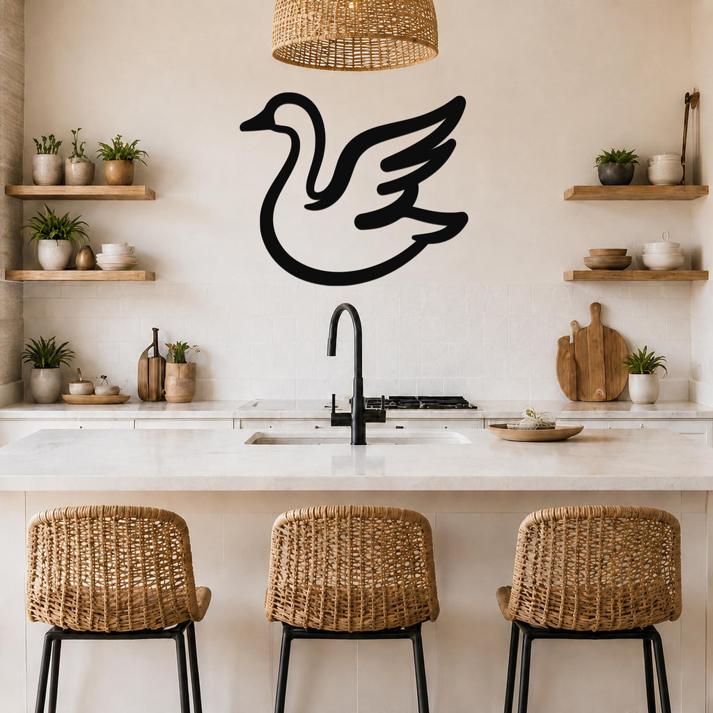 Black metal goose wall art silhouette with wing cutouts, mounted above a kitchen counter in a modern rustic kitchen.
