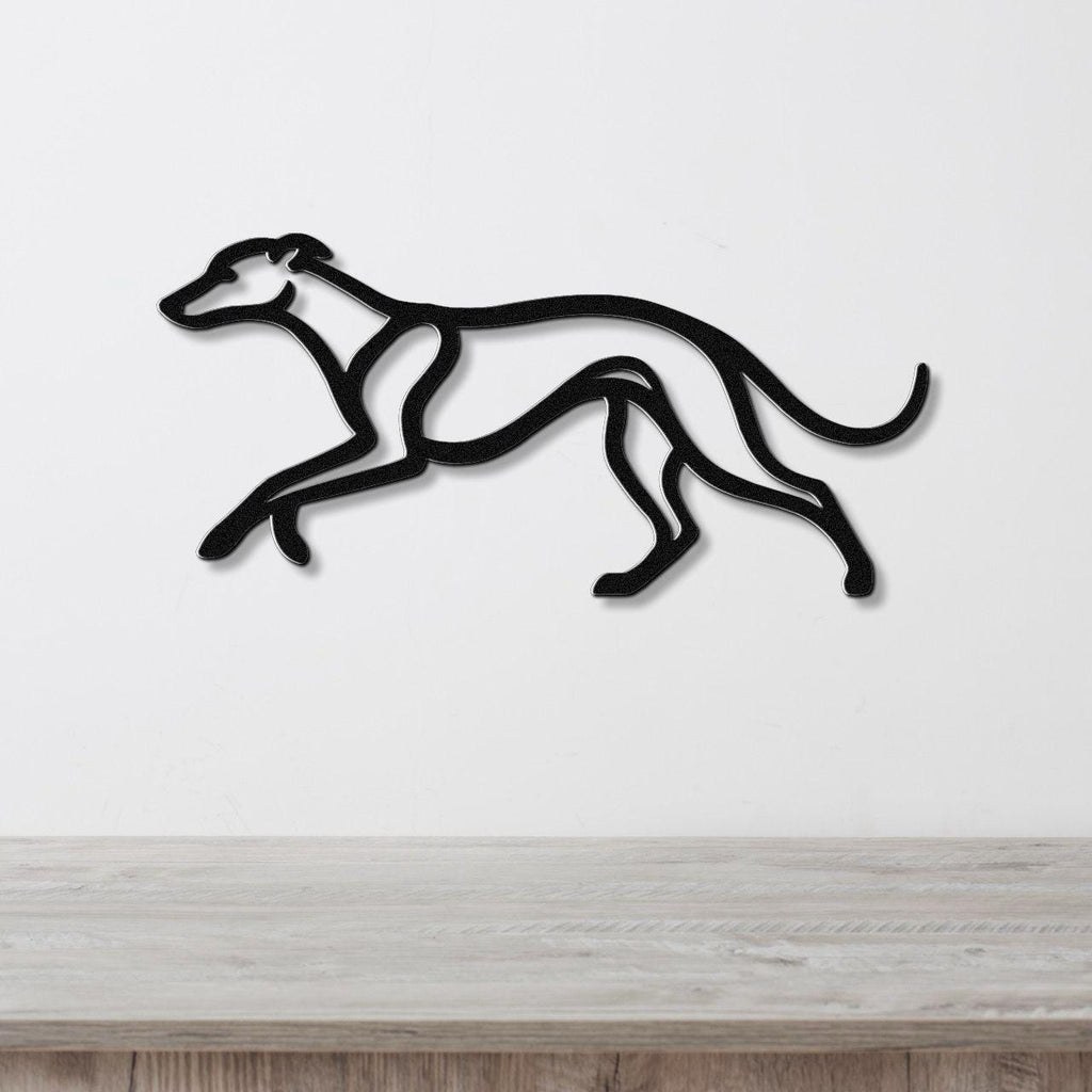 Black metal greyhound wall art with a sleek silhouette design, mounted on a white wall above a light wood surface.