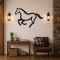 Black metal horse wall art with a running silhouette, mounted on a shiplap wall above a wooden console table in a rustic living room.
