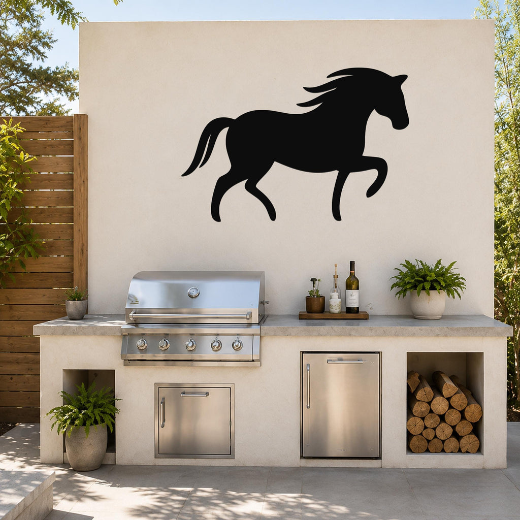 Black metal horse silhouette wall art mounted on a light-colored outdoor wall above a built-in grill and counter.