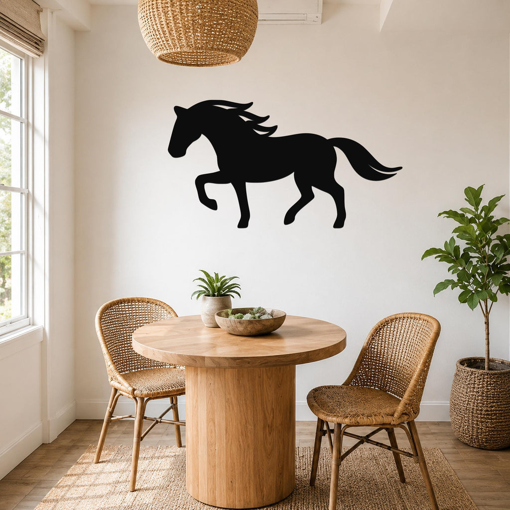 Black metal horse silhouette wall art mounted on a white wall above a round wooden table in a bright dining area.