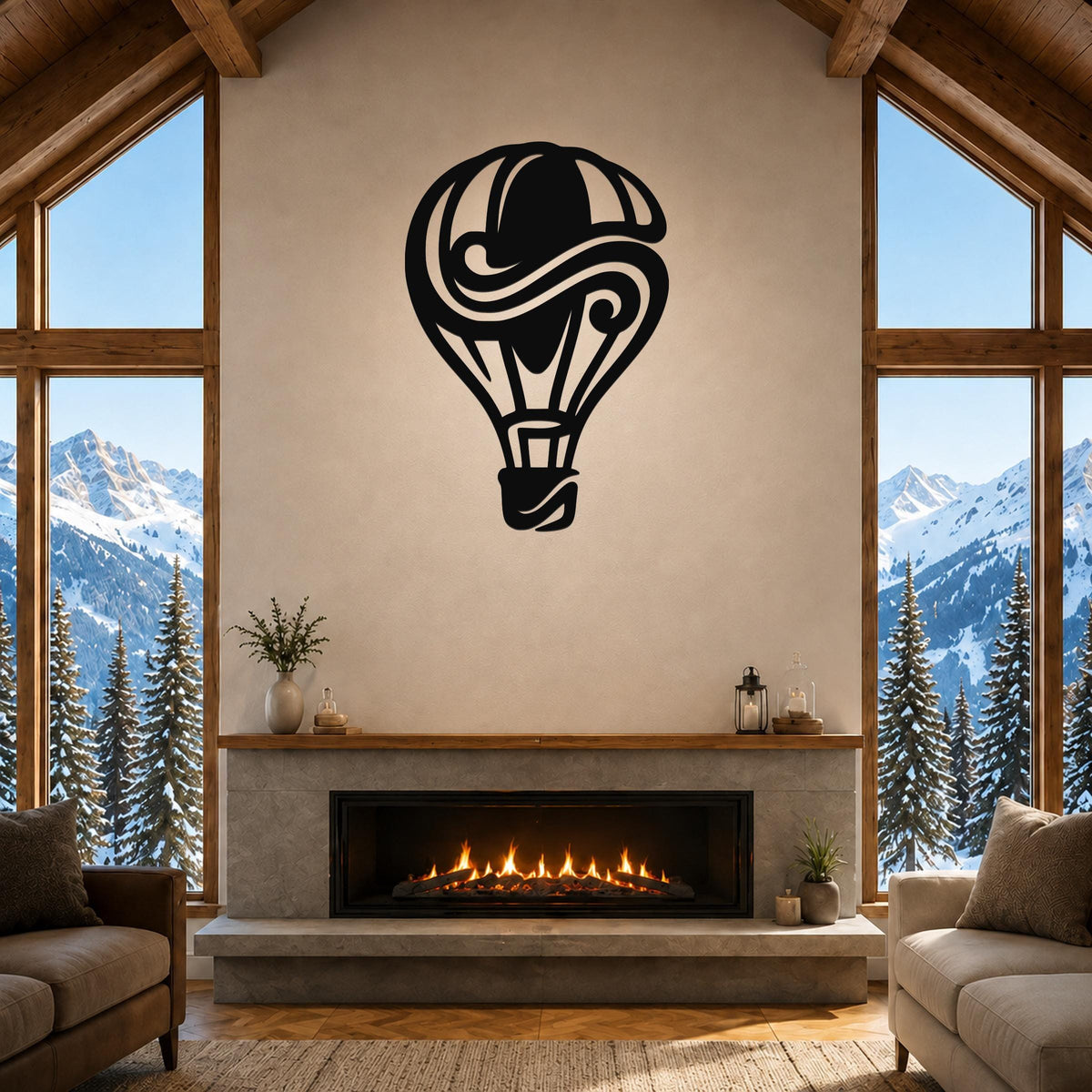 Black metal hot air balloon wall art with swirling internal cutouts, mounted above a fireplace in a rustic living room with large windows overlooking snowy mountains.