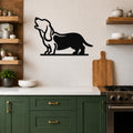 Black metal wall art of a howling basset hound silhouette, mounted on a tiled kitchen wall above a counter.