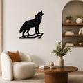 Black metal coyote wall art silhouette howling on a rock, mounted on a living room wall above a white armchair.
