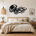 Black metal jellyfish wall art with flowing tentacle cutouts, mounted above a bed in a neutral bedroom.
