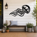 Black metal jellyfish wall art with flowing tentacle cutouts, mounted on a white shiplap wall above a wooden bench on a porch.