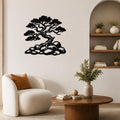 Black metal wall art silhouette of a bonsai-style juniper tree with rocky base, mounted on a living room wall above a round wooden coffee table.