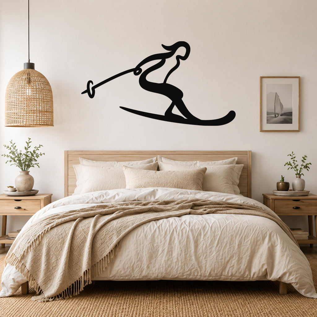 Black metal wall art of a skier silhouette with ski poles, mounted above a bed in a bedroom.