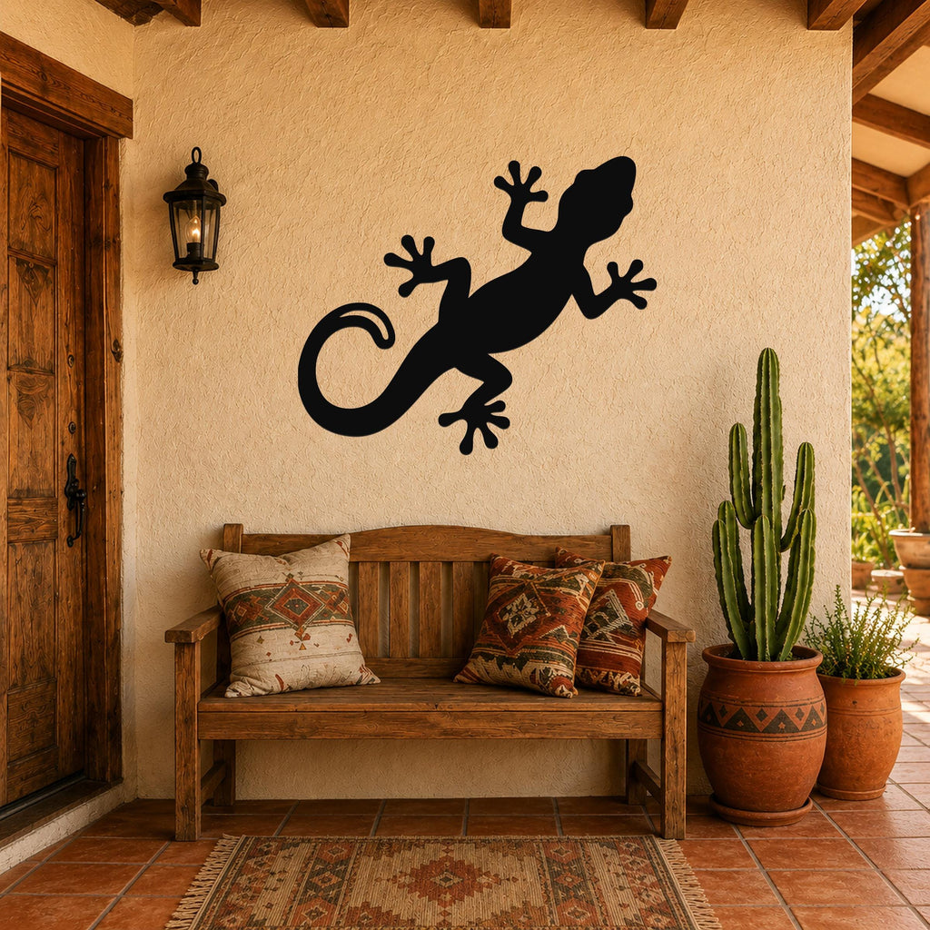Black metal lizard wall art silhouette mounted on a stucco wall above a wooden bench in a patio entryway.
