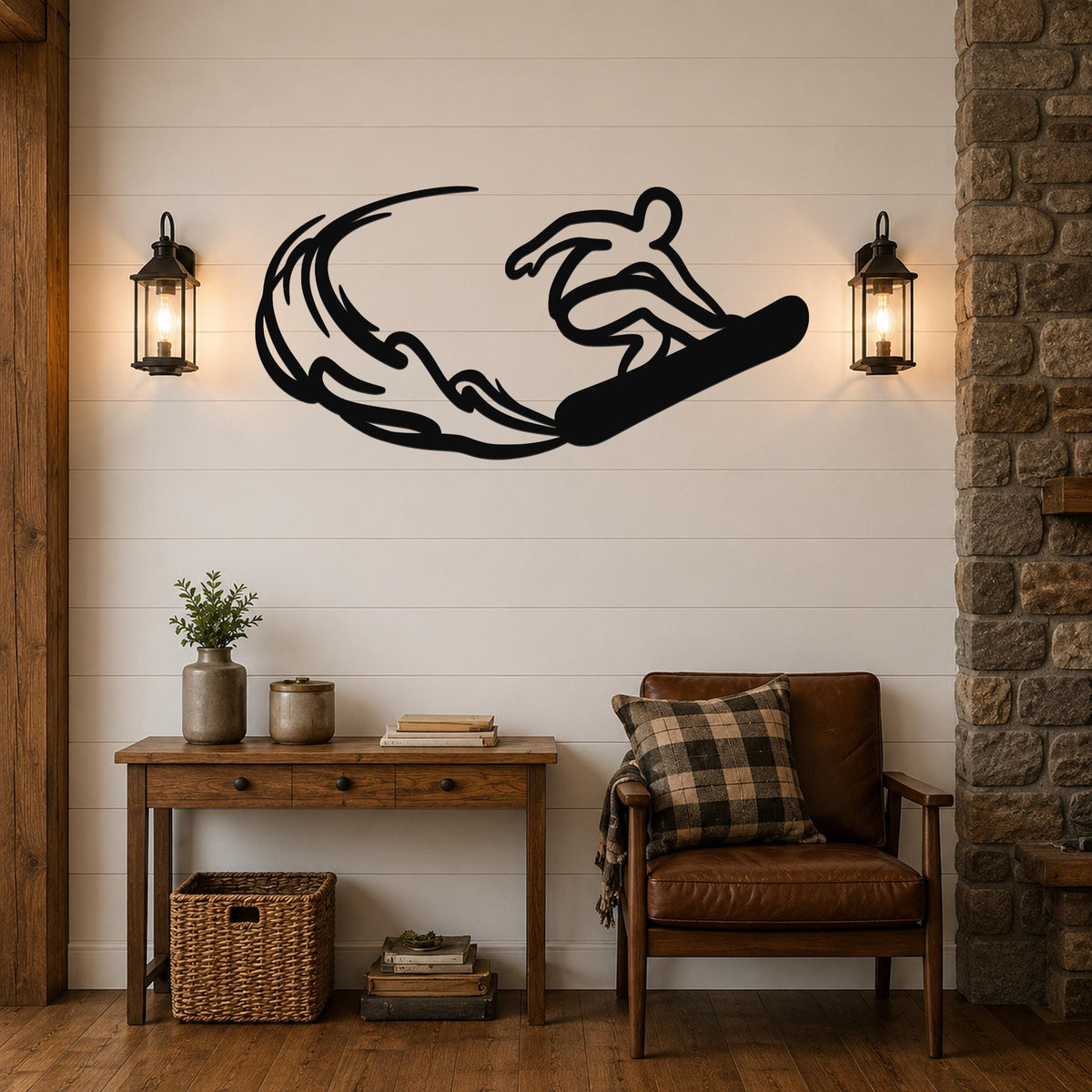 Black metal wall art silhouette of a snowboarder in motion, mounted above a wooden console table in a living room with shiplap walls and lanterns.