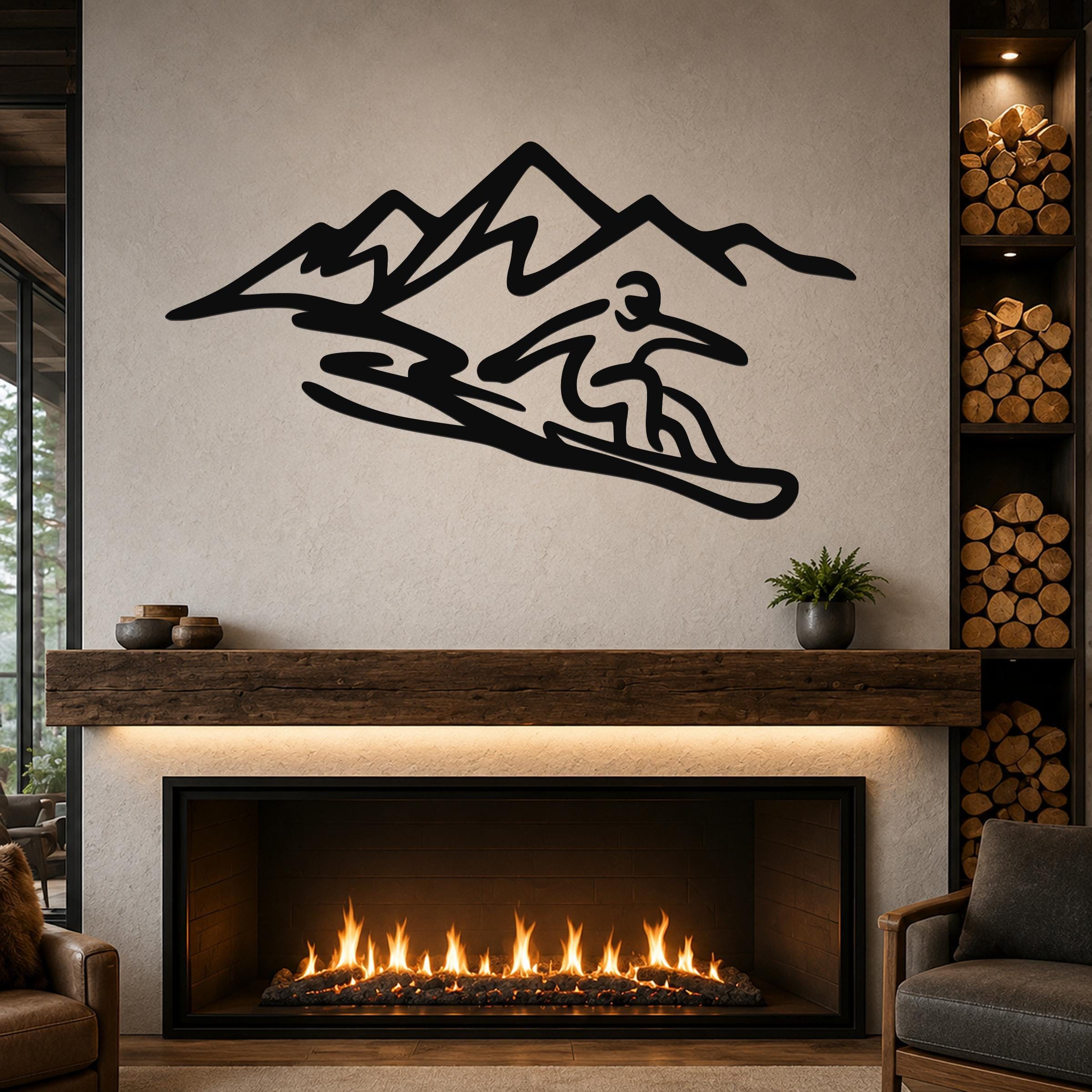 Black metal wall art with a snowboarder silhouette and mountain range, mounted above a fireplace in a living room.