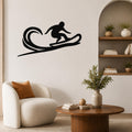 Black metal wall art silhouette of a surfer riding a wave, mounted on a living room wall above a white armchair.
