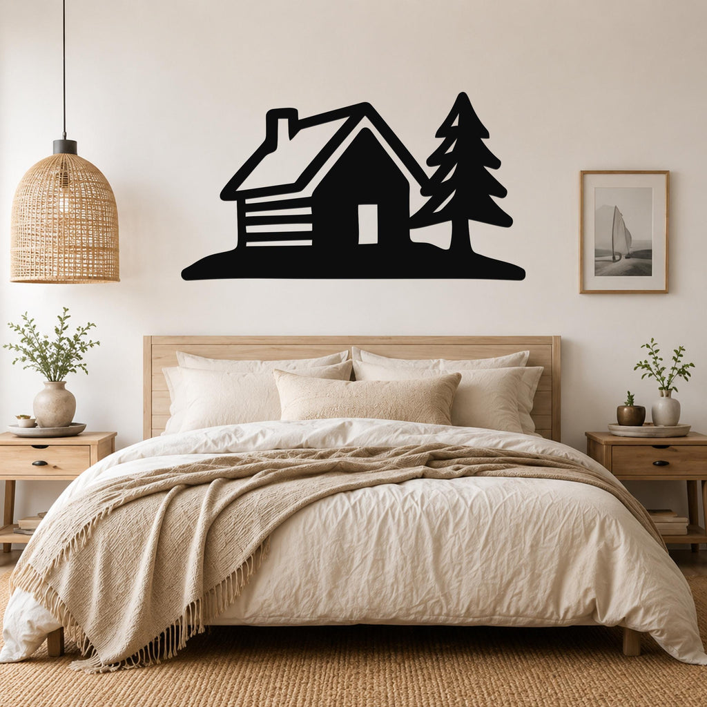 Black metal wall art featuring a cabin and pine tree silhouette, mounted above a bed in a neutral bedroom.