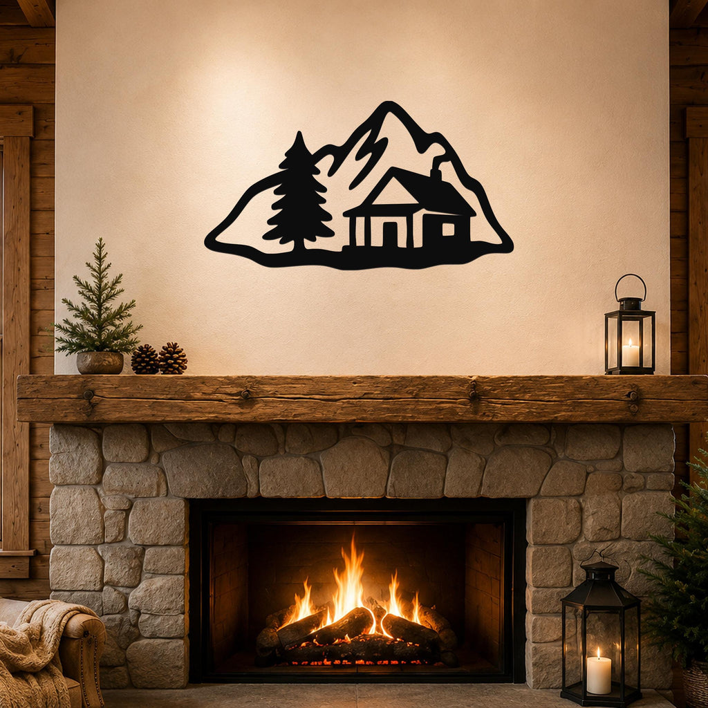 Black metal wall art silhouette of a mountain cabin with a pine tree, mounted above a stone fireplace in a rustic living room.