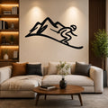 Black metal wall art featuring a skier silhouette descending a mountain, mounted above a sofa in a living room.