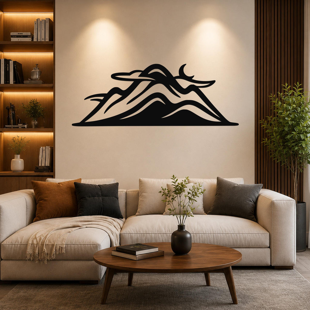 Black metal mountain silhouette wall art with layered peaks and internal cutouts, mounted above a beige sofa in a living room.