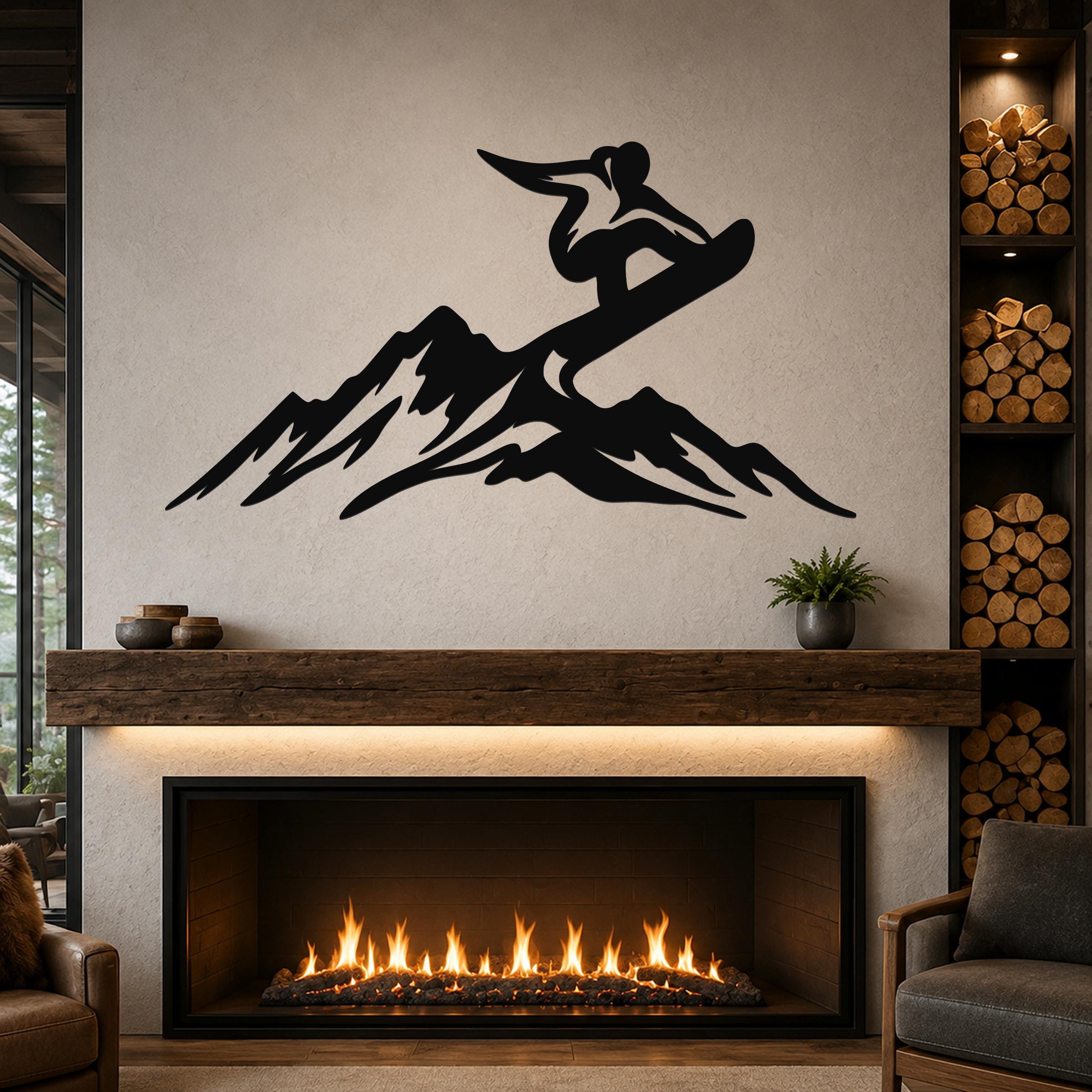Black metal wall art featuring a snowboarder silhouette above mountain peaks, mounted above a fireplace in a living room.