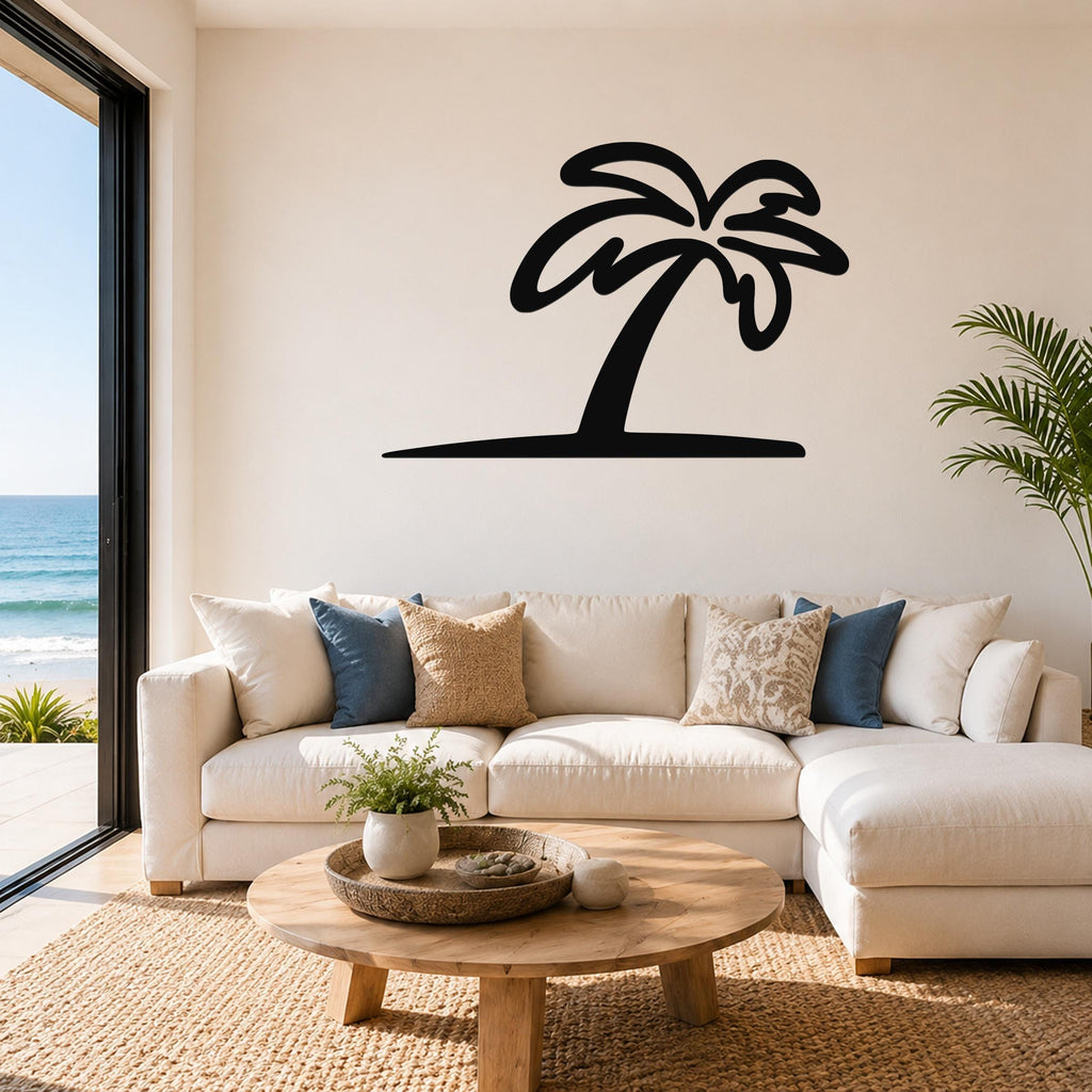 Black metal palm tree wall art with a silhouette design, mounted above a white sofa in a bright living room with ocean views.