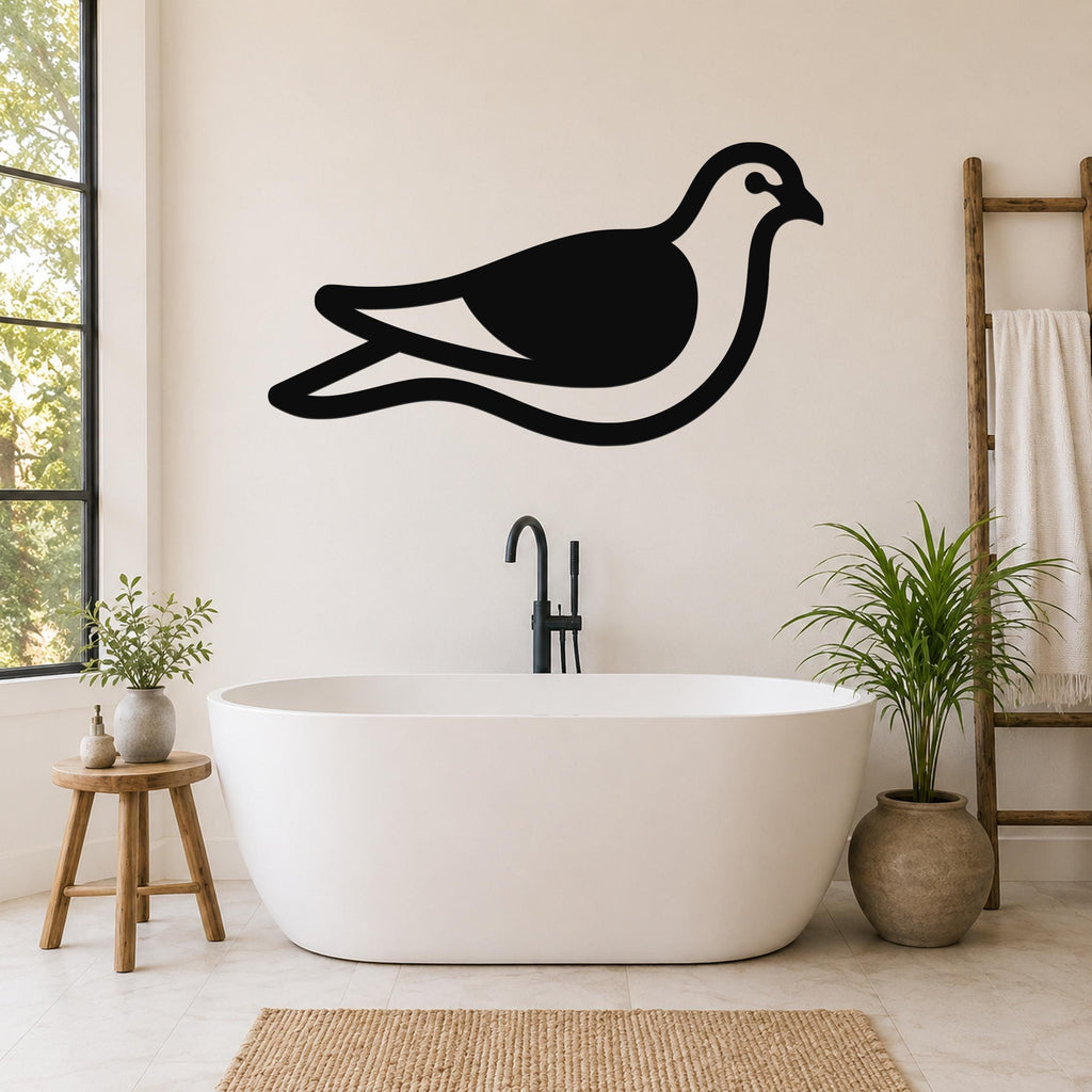 Black metal pigeon wall art silhouette mounted on a bathroom wall above a freestanding tub, with a wooden ladder and potted plants nearby.