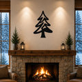 Black metal pine tree wall art with layered branch cutouts, mounted above a stone fireplace in a rustic living room.