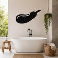 Black metal eggplant wall art silhouette mounted on a bathroom wall above a freestanding tub.