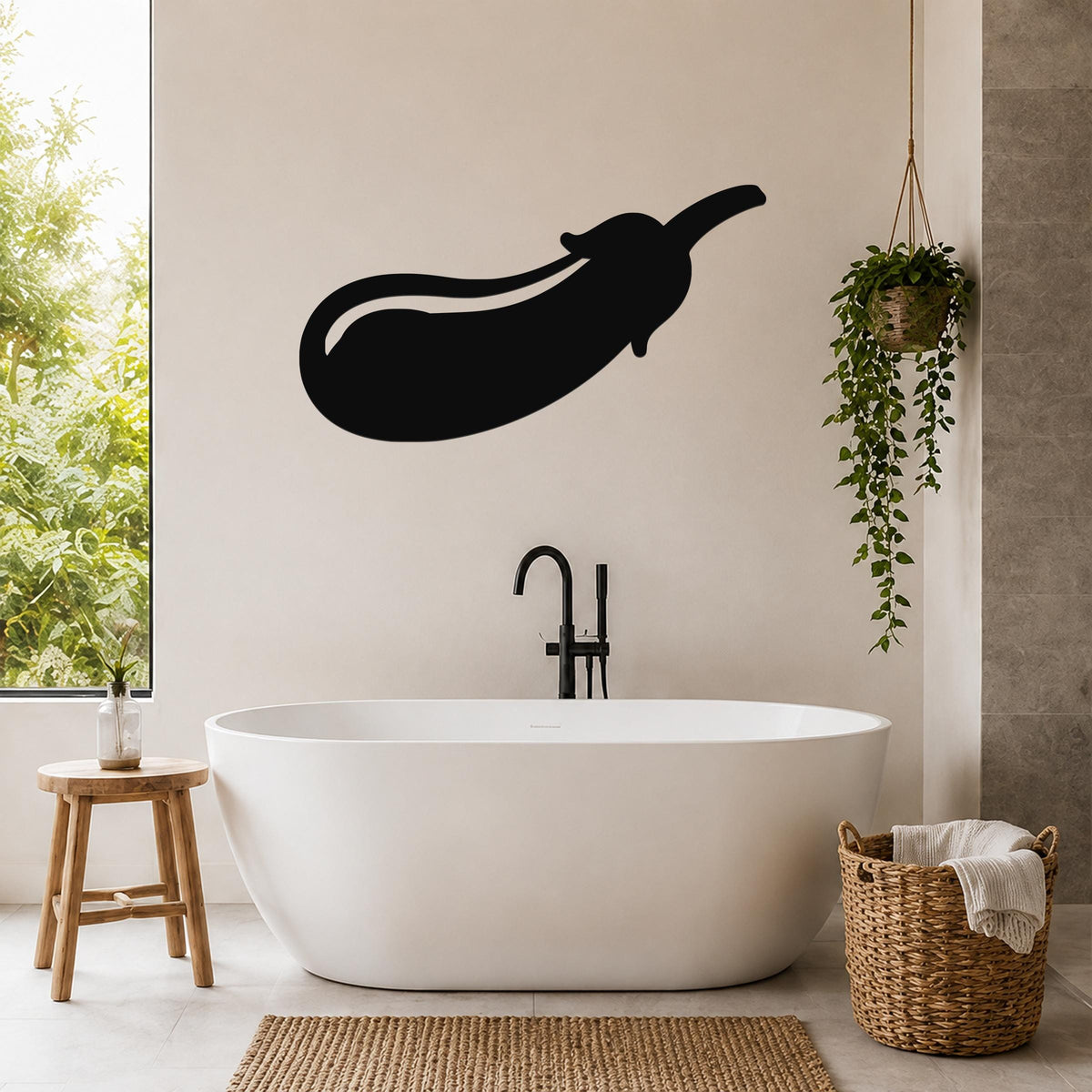 Black metal eggplant wall art silhouette mounted on a bathroom wall above a freestanding tub.
