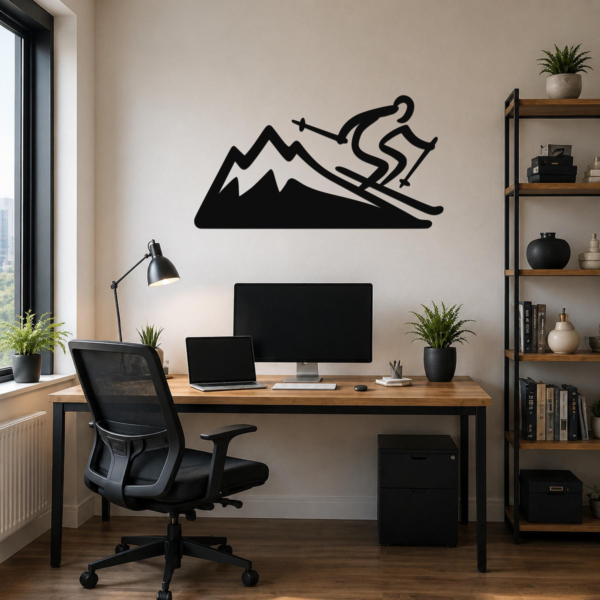 Black metal wall sculpture of a skier on a mountain, mounted above a wooden desk in a home office.