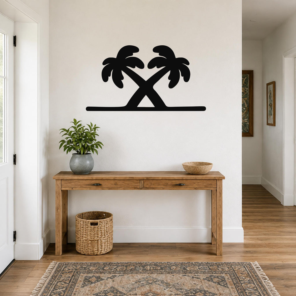 Black metal palm tree wall art with two crossed silhouettes, mounted above a wooden console table in a bright entryway.