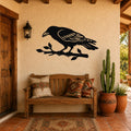 Black metal raven wall art with detailed feather cutouts, perched on a branch, mounted on a stucco wall above a wooden bench in a rustic patio entryway.