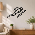 Black metal runner wall art with motion-line cutouts, mounted above a wooden console in a living room.