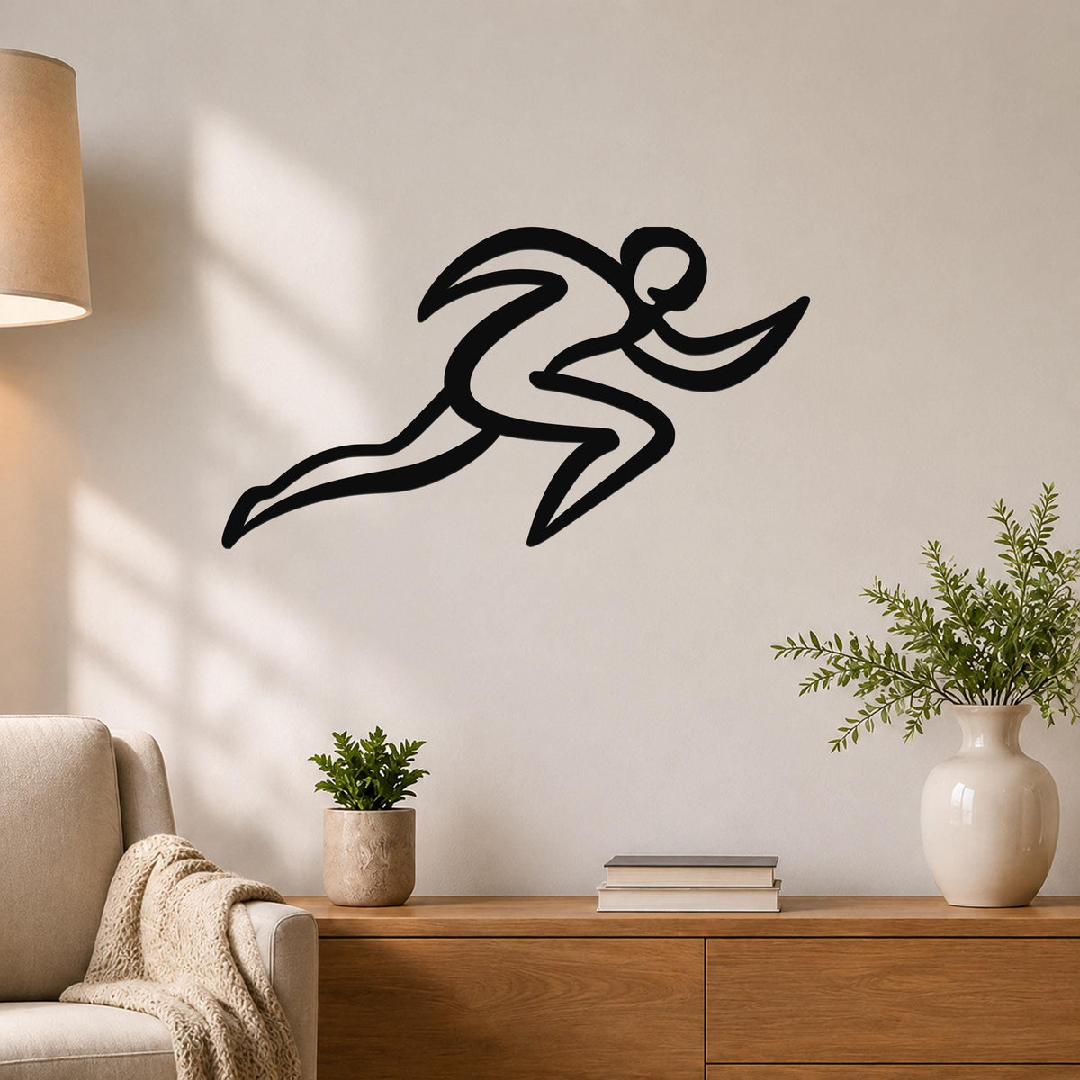 Black metal runner wall art with motion-line cutouts, mounted above a wooden console in a living room.
