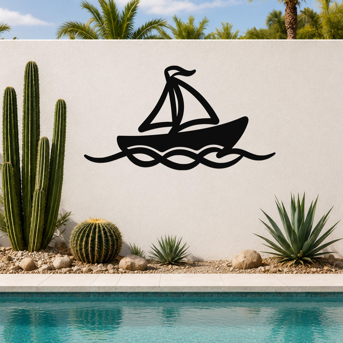 Black metal sailboat wall art with wave cutouts, mounted on a white outdoor wall above a pool with cacti and palm trees in the background.