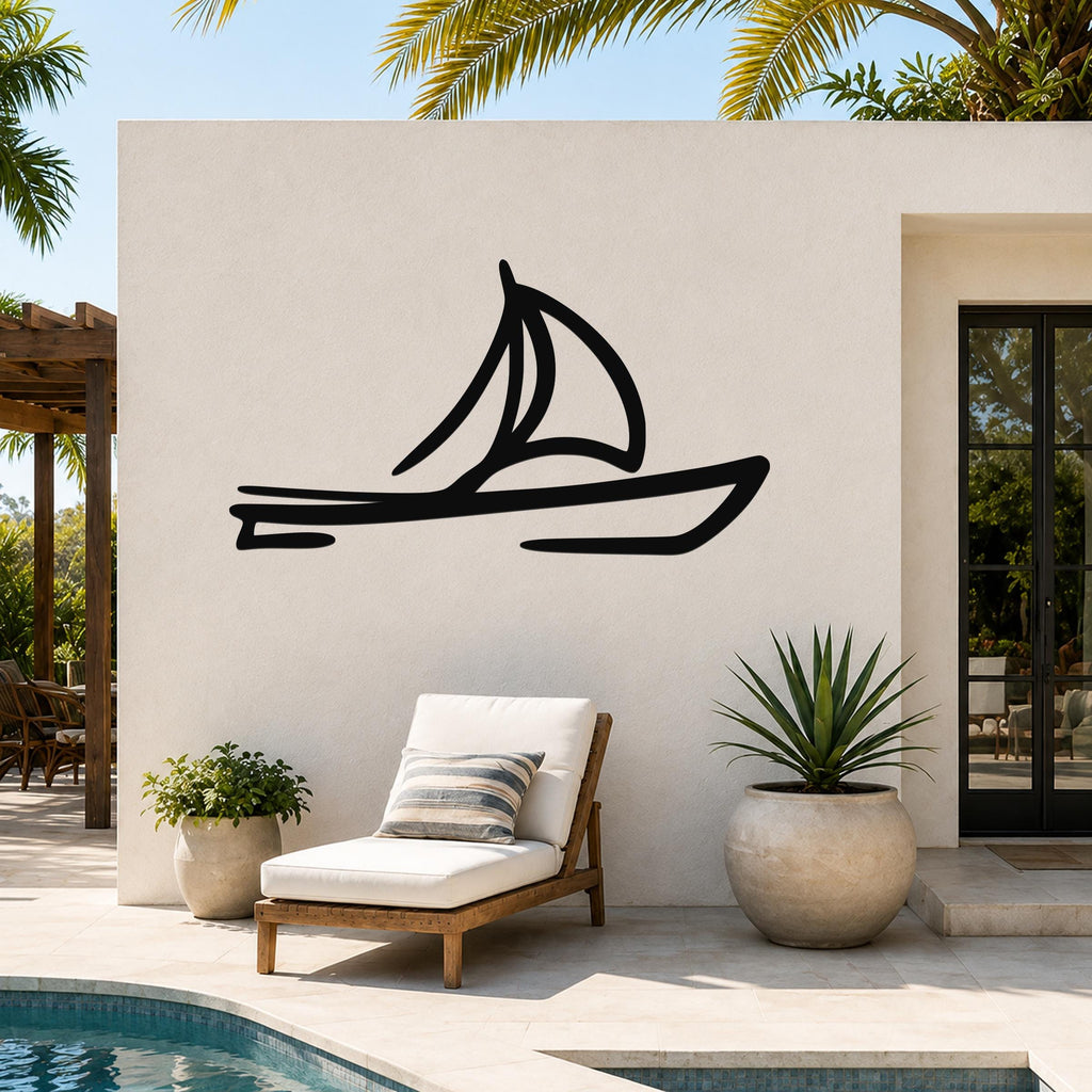 Black metal sailboat wall art with a minimalist silhouette design, mounted on a white outdoor wall above a lounge chair near a pool.