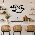 Black metal seagull wall art with motion-line cutouts, mounted above a kitchen counter in a bright, modern kitchen.