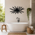 Black metal wall art in a sea urchin silhouette with radiating spines, mounted on a bathroom wall above a freestanding tub.