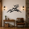 Black metal wall art featuring a skier silhouette in motion above mountain peaks, mounted on a shiplap wall above a wooden console table in a living room.