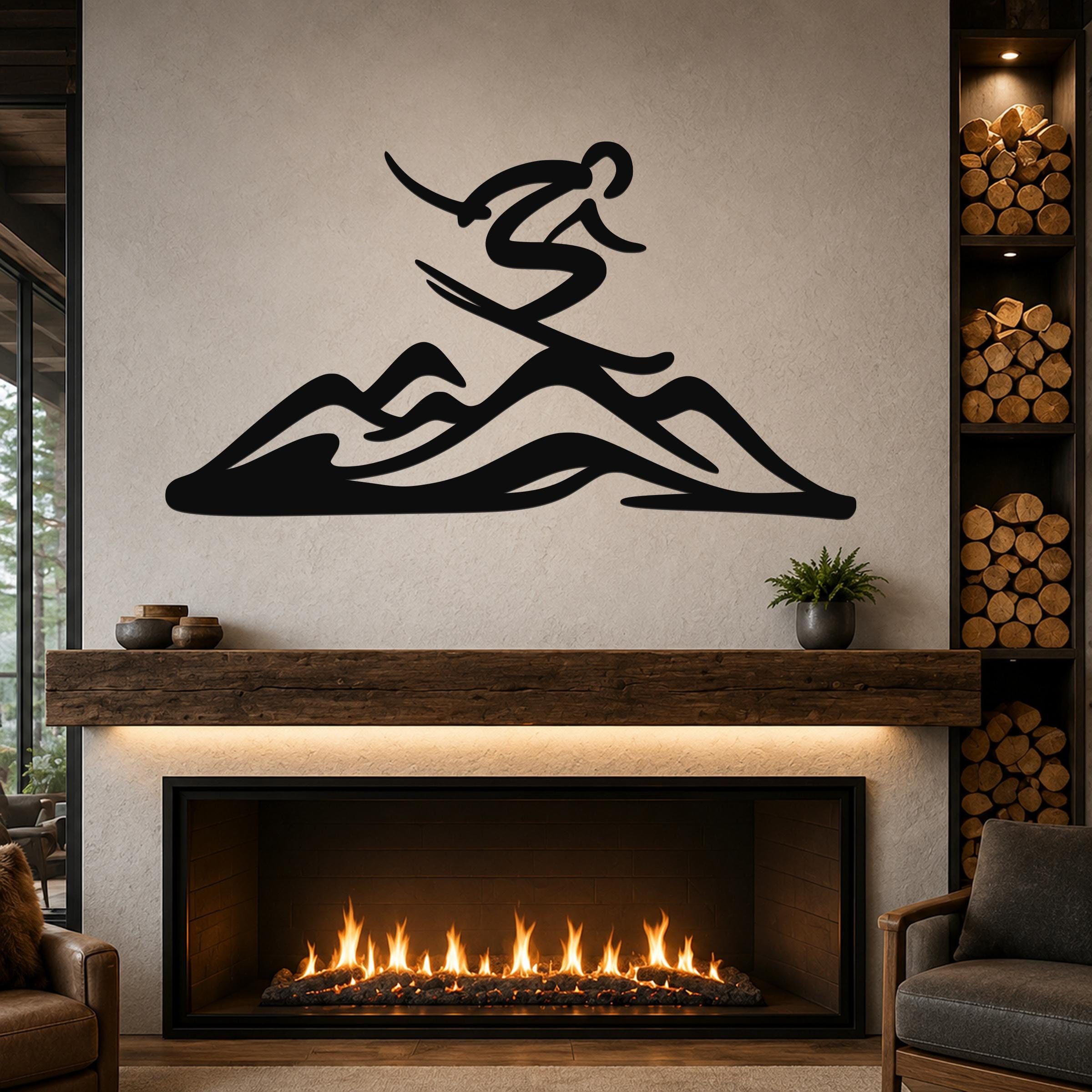 Black metal wall art featuring a skier silhouette above mountain peaks, mounted above a fireplace in a living room.