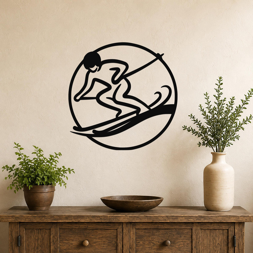 Black metal wall art featuring a circular silhouette of a skier in motion, mounted on a beige wall above a wooden console table with potted plants.