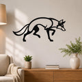 Black metal coyote wall art with a sleek silhouette design, mounted on a living room wall above a wooden console table.