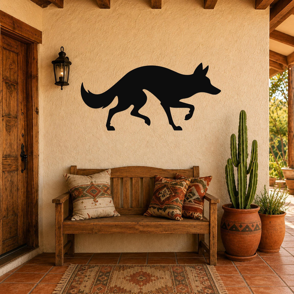 Black metal coyote wall art silhouette mounted on a stucco wall above a wooden bench in a patio entryway.