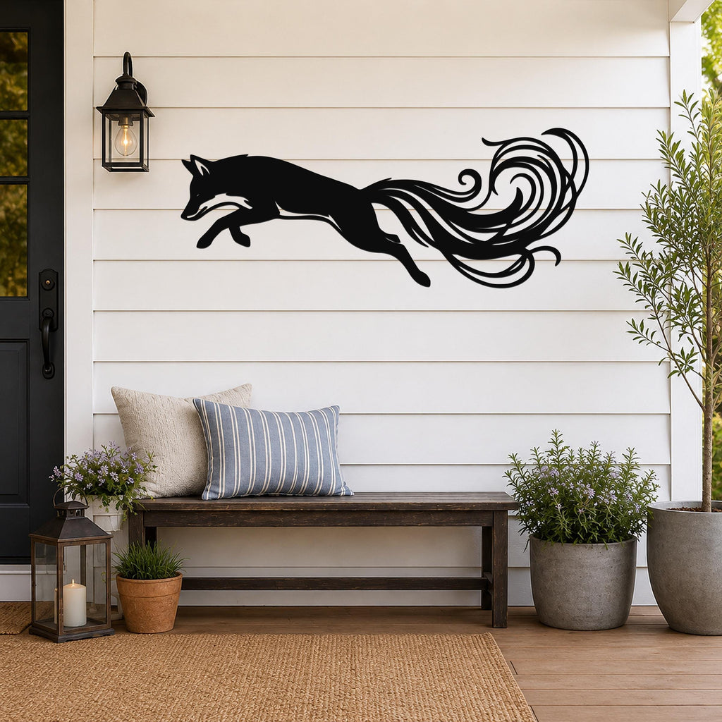 Black metal fox wall art with flowing tail cutouts, mounted on a white shiplap wall above a wooden bench on a porch.