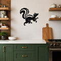 Black metal skunk wall art silhouette with a raised tail, mounted on a white tiled kitchen wall above a counter.