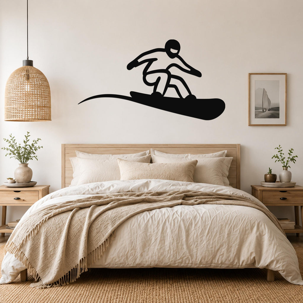 Black metal snowboarder wall art with a bold silhouette and motion line, mounted above a bed in a neutral bedroom.