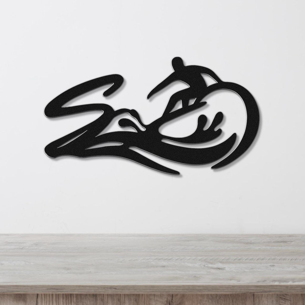 Black metal wall art featuring a surfer silhouette riding a wave, mounted on a white wall above a light wood counter.