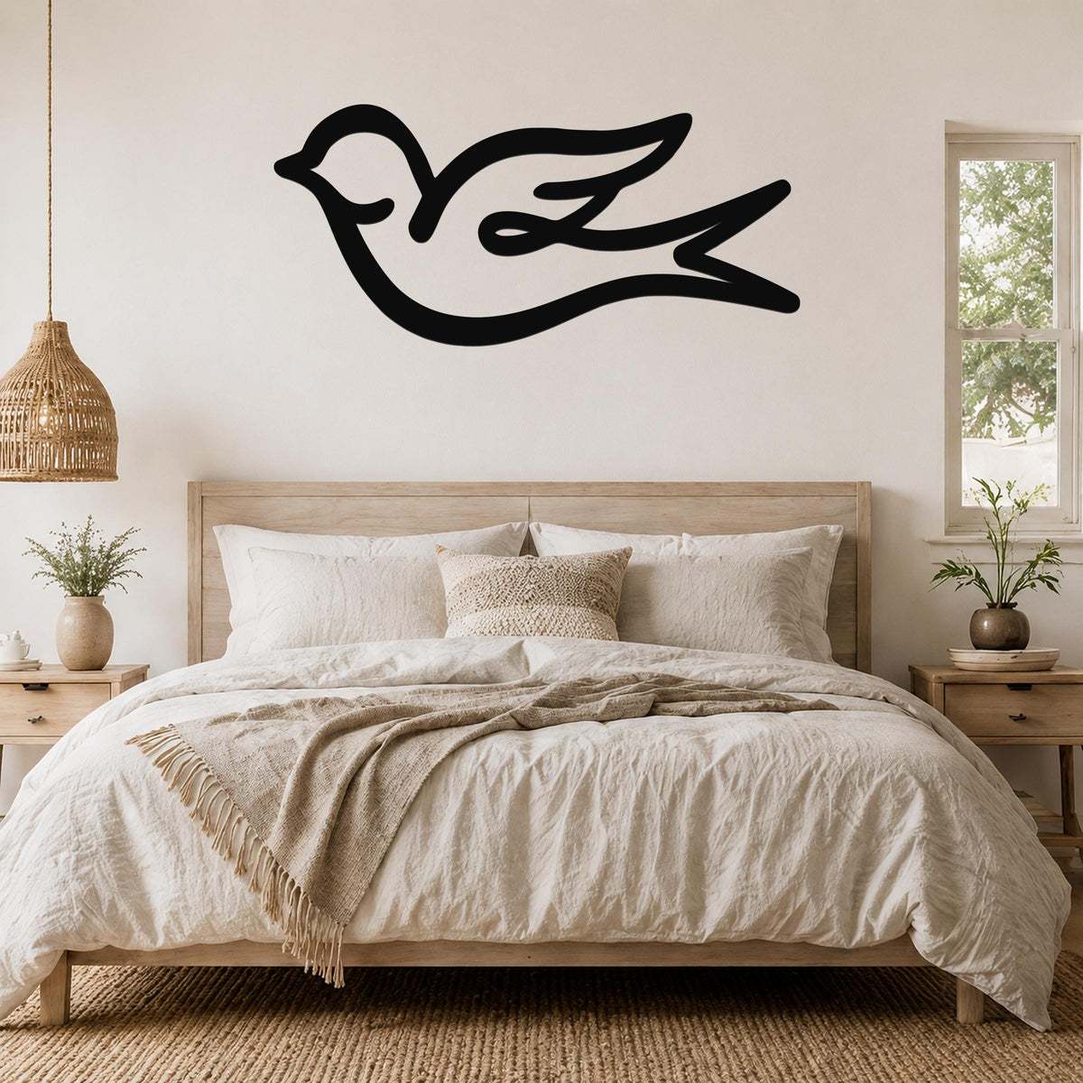 Black metal swallow bird wall art with a graceful silhouette, mounted above a wooden bed in a neutral bedroom.
