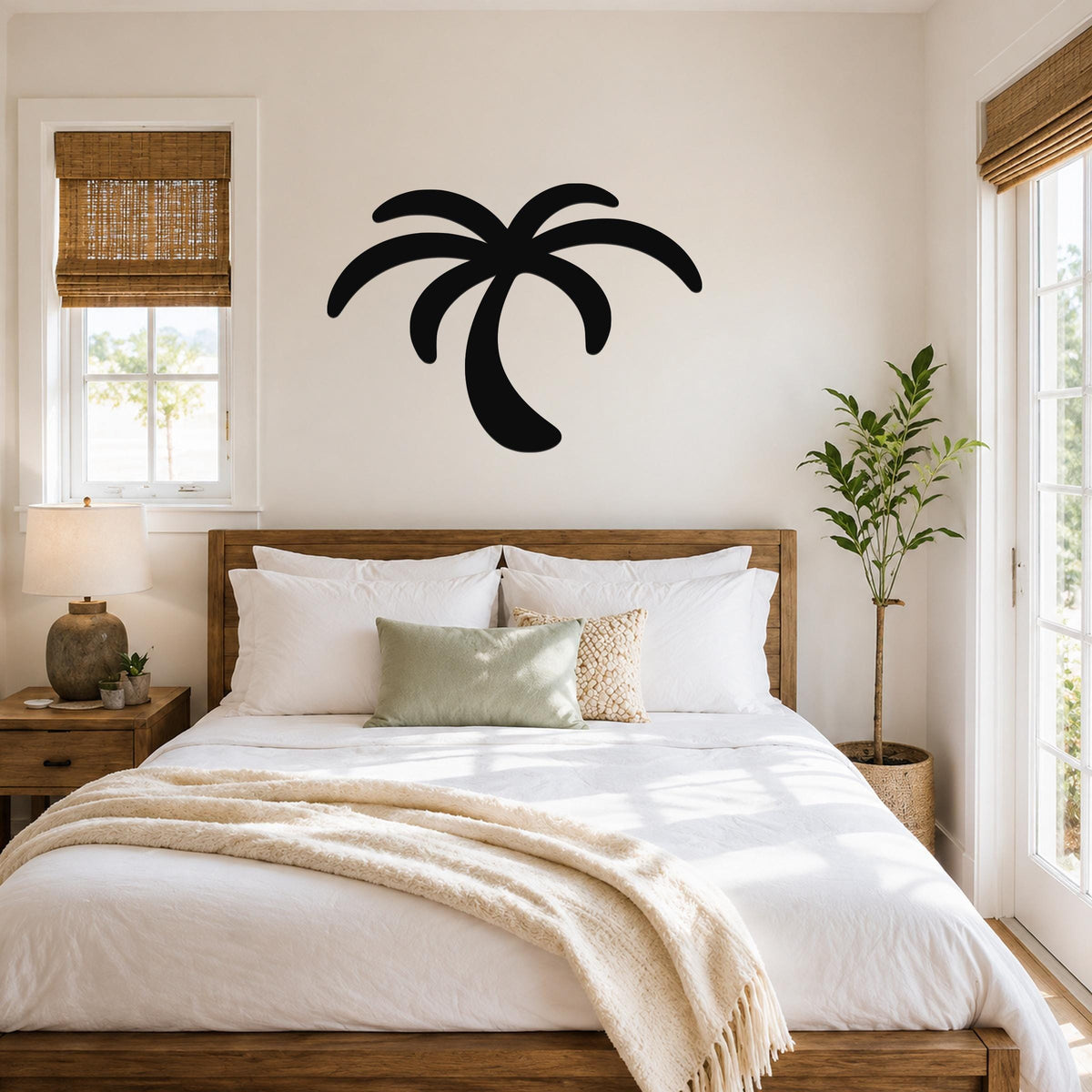 Black metal palm tree wall art with curved frond cutouts, mounted above a wooden bed in a bright bedroom.