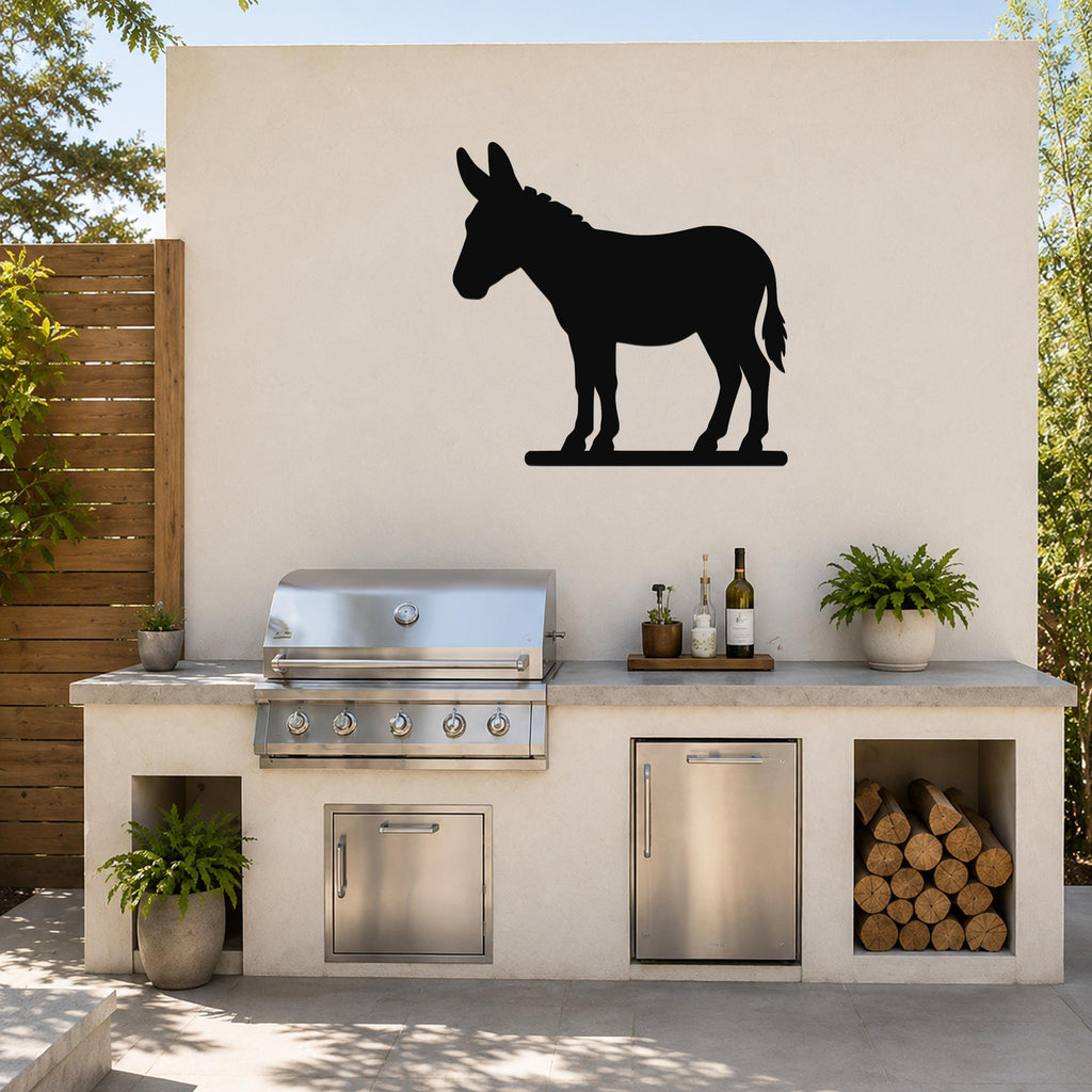 Black metal donkey silhouette wall art mounted on a light-colored outdoor wall above a built-in grill and counter.