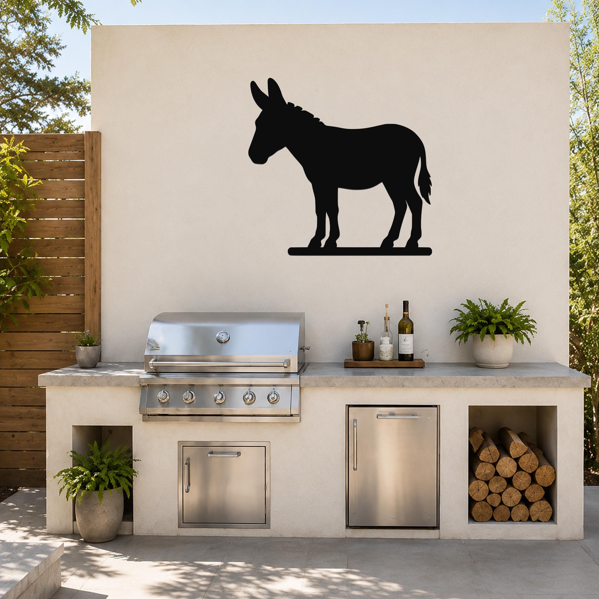 Black metal donkey silhouette wall art mounted on a light-colored outdoor wall above a built-in grill and counter.