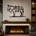 Black metal wall art silhouette of a burro with saddle and pack, mounted above a fireplace in a living room.