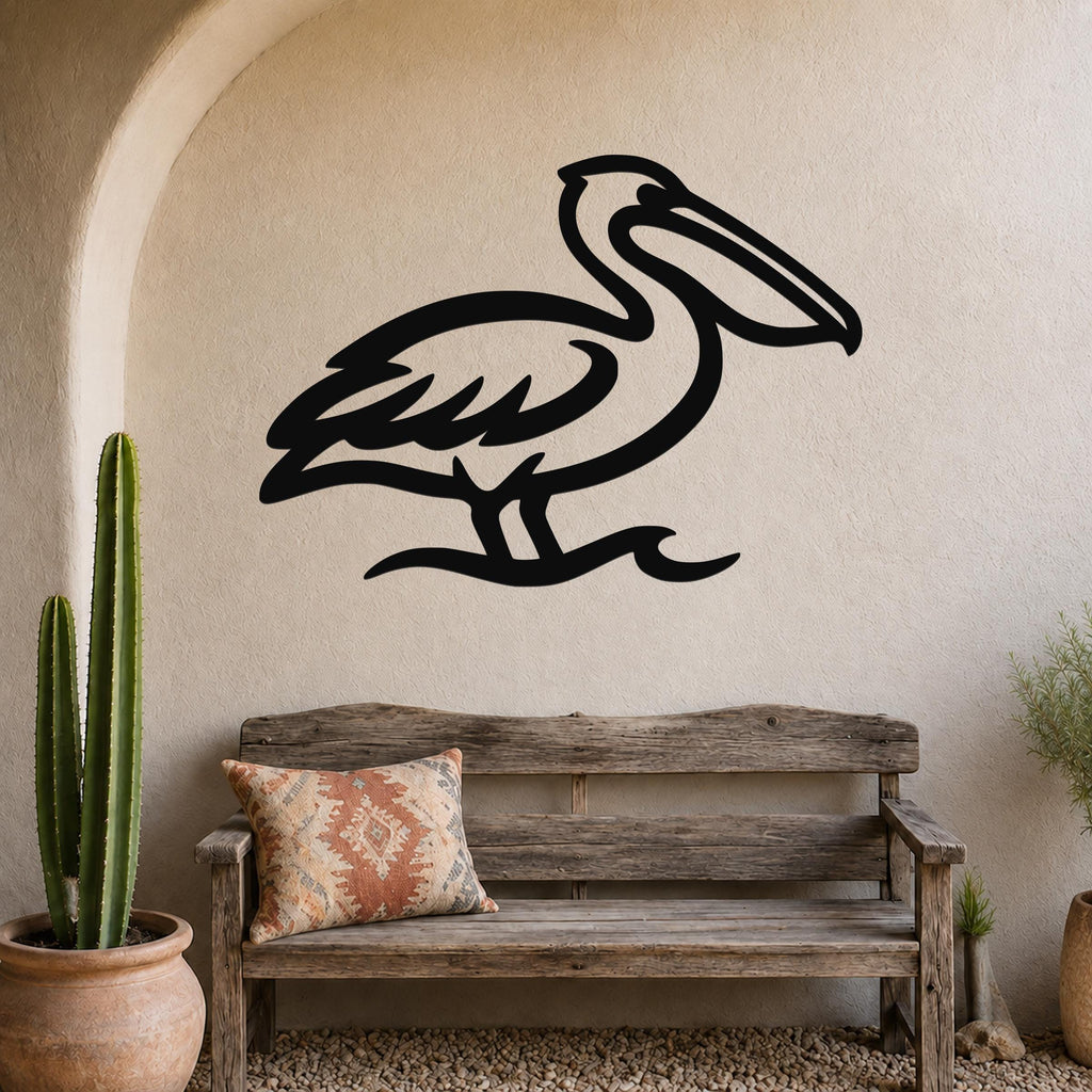 Black metal pelican wall art with a silhouette design, mounted on a textured beige wall above a wooden bench in a coastal-style entryway.